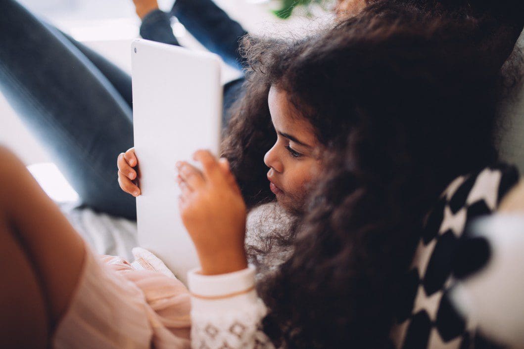 Child playing on a tablet.