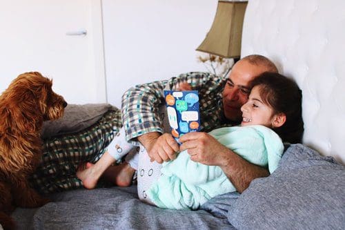 Child reading with their parent.
