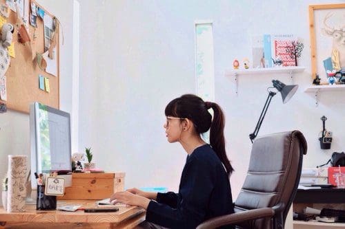 Woman on a computer doing research.