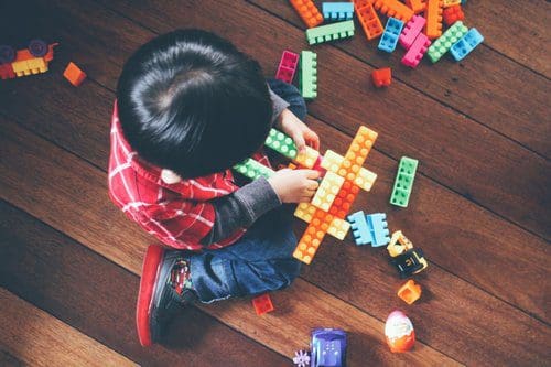 Child playing with legos.