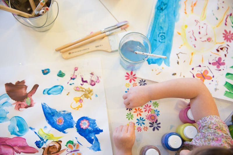 Child painting flowers.
