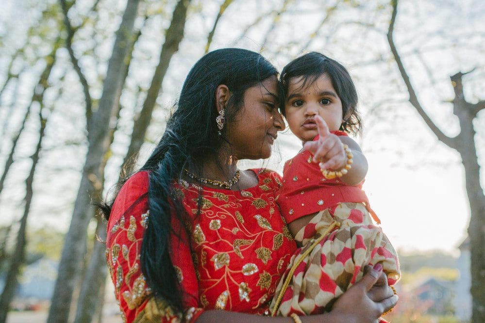 Mother holding daughter.