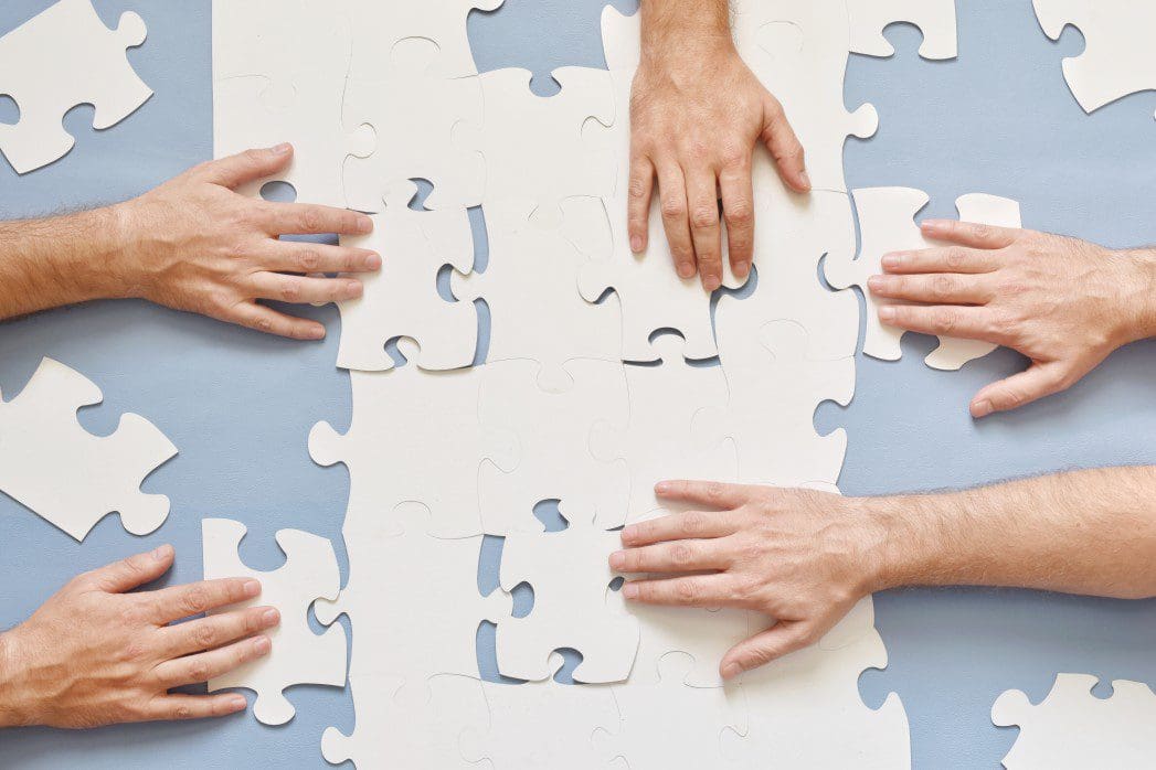 Hands working on a puzzle