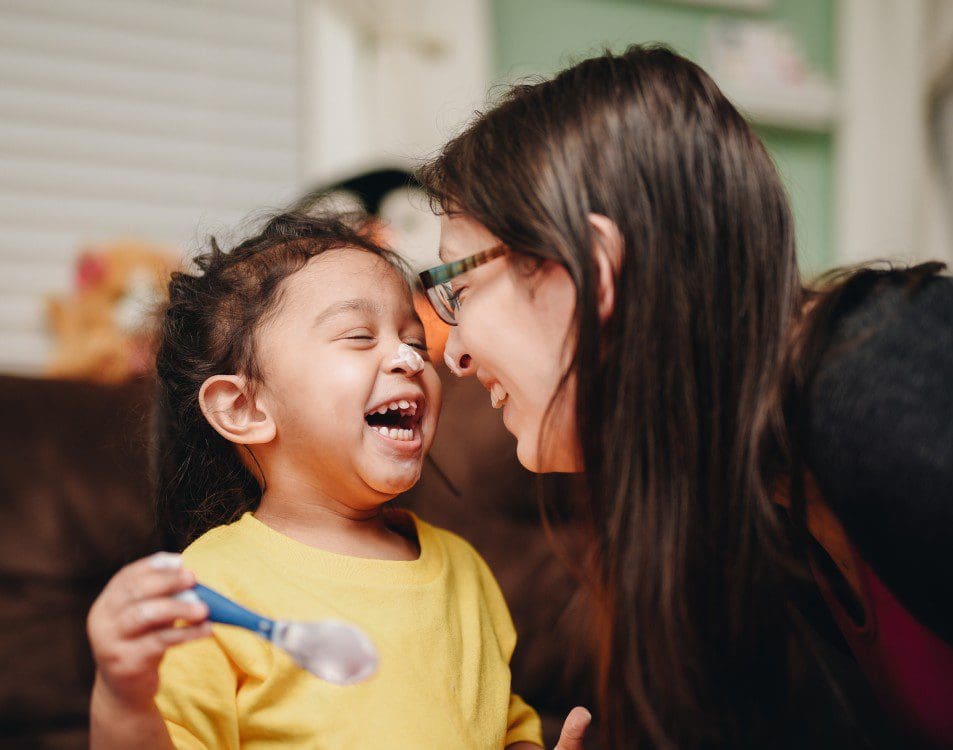 Adult and child laughing