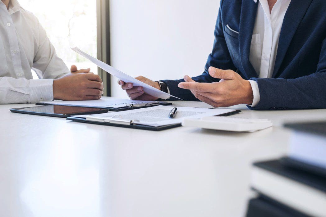 Two people reviewing insurance paperwork