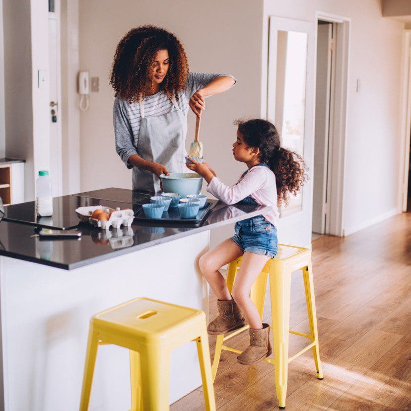 Child and adult cooking together