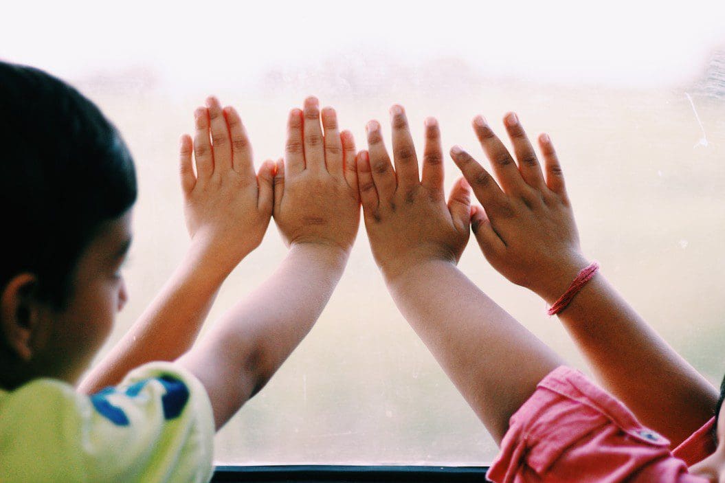 Child hands on a window