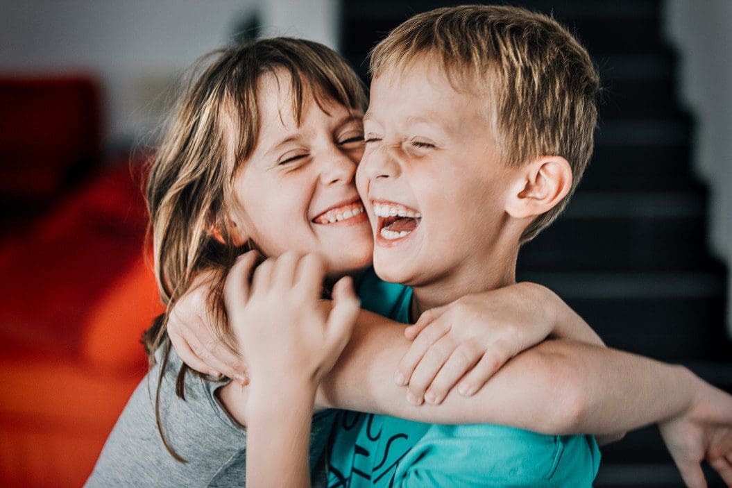 Two child siblings hugging