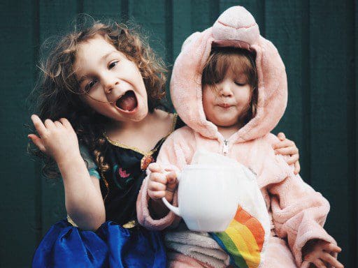 Children playing and receiving positive reinforcement.
