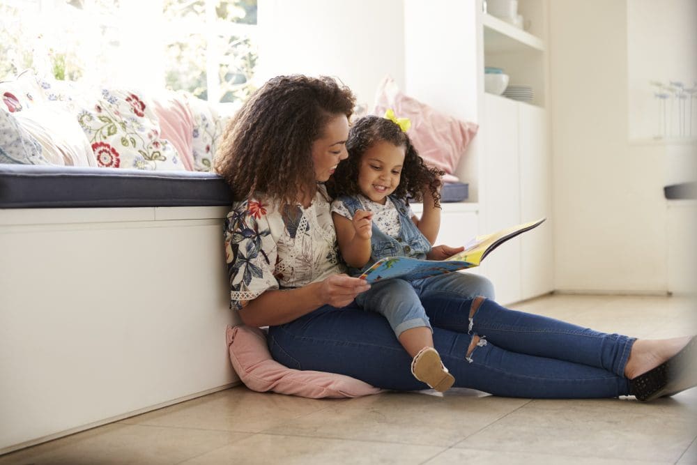 Mom and daughter reading books together
